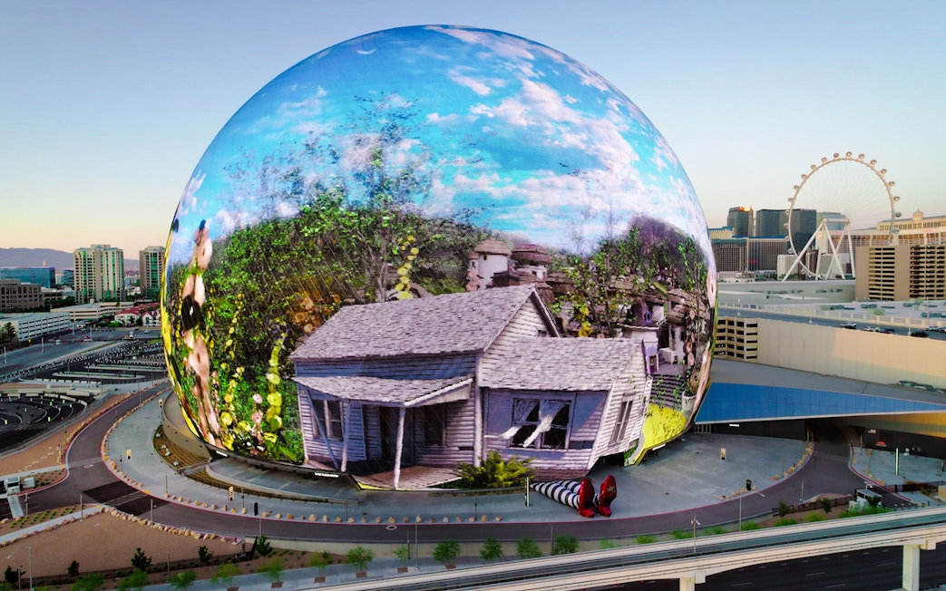 Sphere in Las Vegas displaying Wizard of Oz scene with house and ruby slippers.