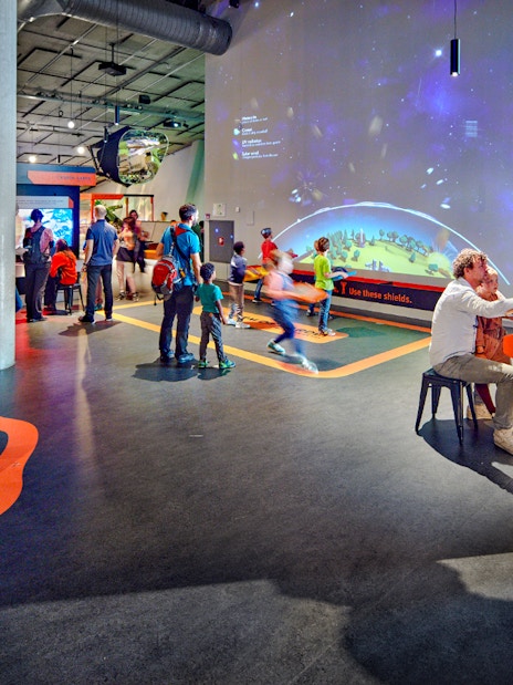 Interactive exhibits at NEMO Science Museum with visitors engaging in activities.