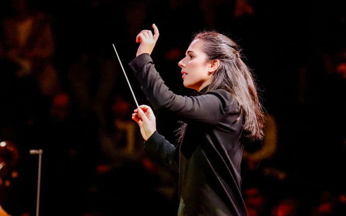 Conductor leading orchestra inside St. Stephen's Cathedral, Vienna.