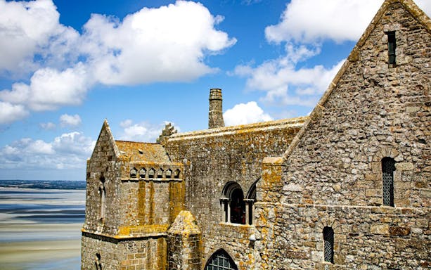 Mont-Saint-Michel Abbey stone architecture with coastal view in Normandy, France.