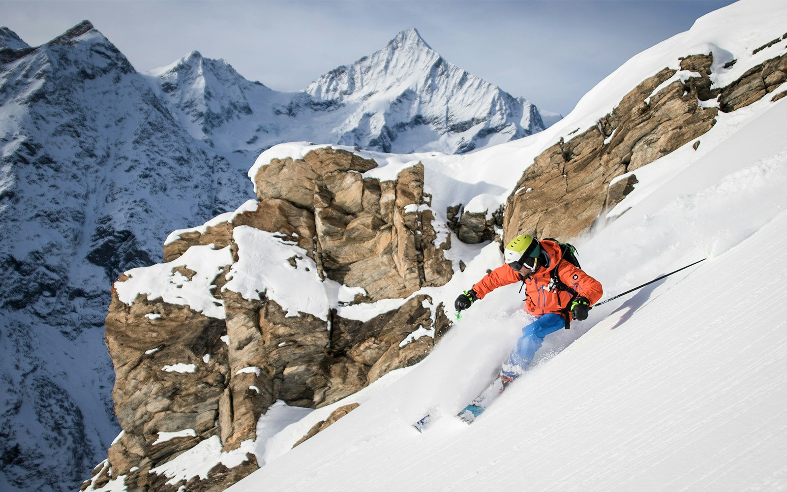Skiers descending snowy slopes with Matterhorn view at Gornergrat, Switzerland.