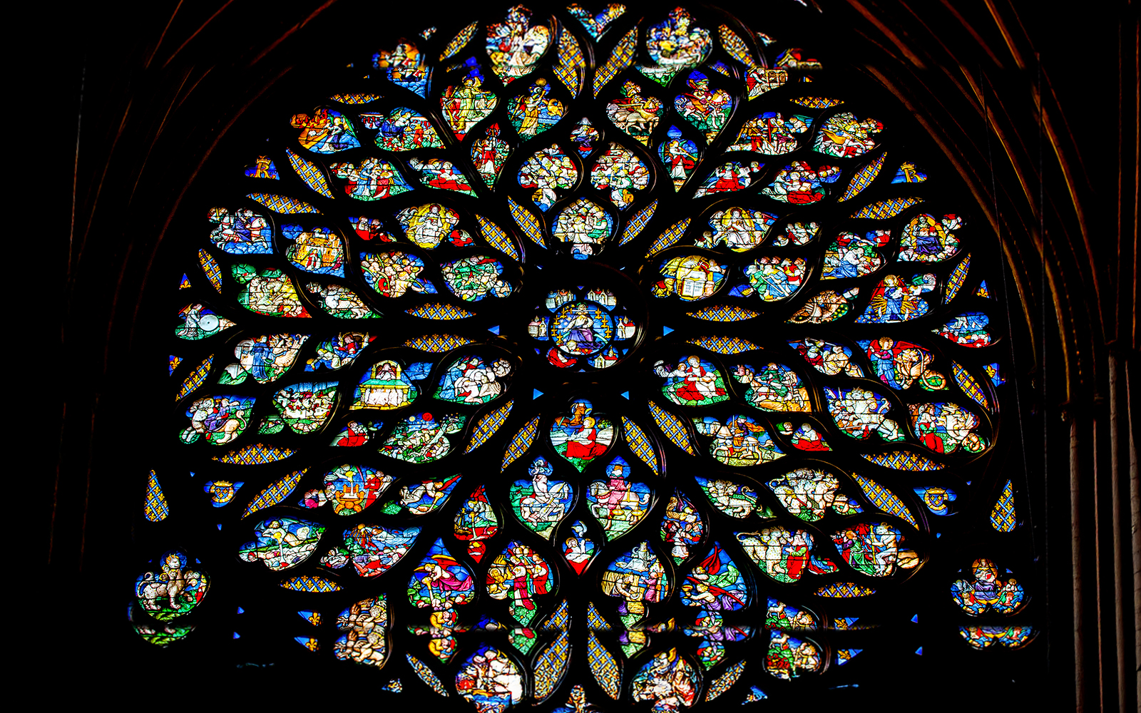 Saint Chapelle rose window with intricate circular stained glass design in Paris, France.