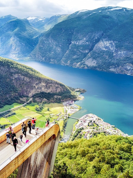 Visitors on Stegastein platform overlooking Aurlandsfjord in Norway.