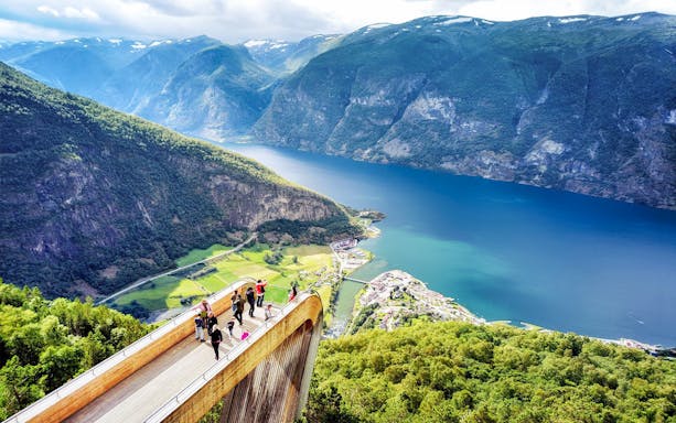 Visitors on Stegastein platform overlooking Aurlandsfjord in Norway.