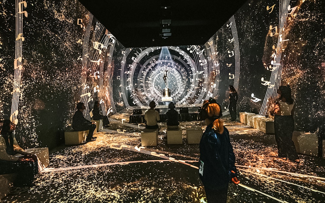 Visitors at Vienna's Johann Strauss Museum immersed in a musical light show.