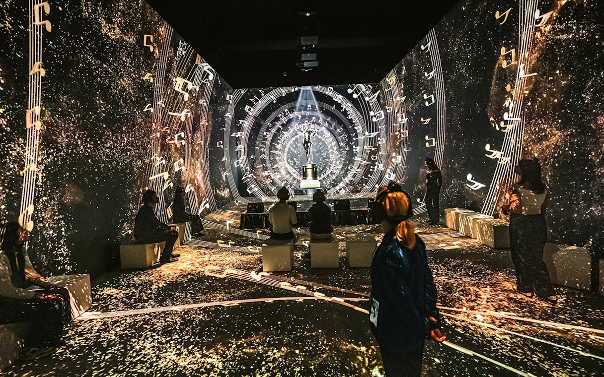 Visitors at Vienna's Johann Strauss Museum immersed in a musical light show.