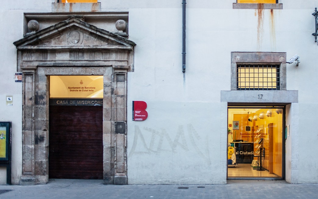 Facade of Casa de Misericordia in Raval, Barcelona, highlighting historical architecture.