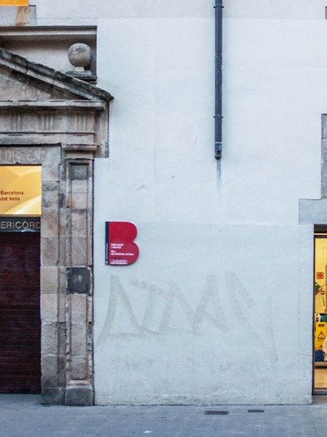 Facade of Casa de Misericordia in Raval, Barcelona, highlighting historical architecture.