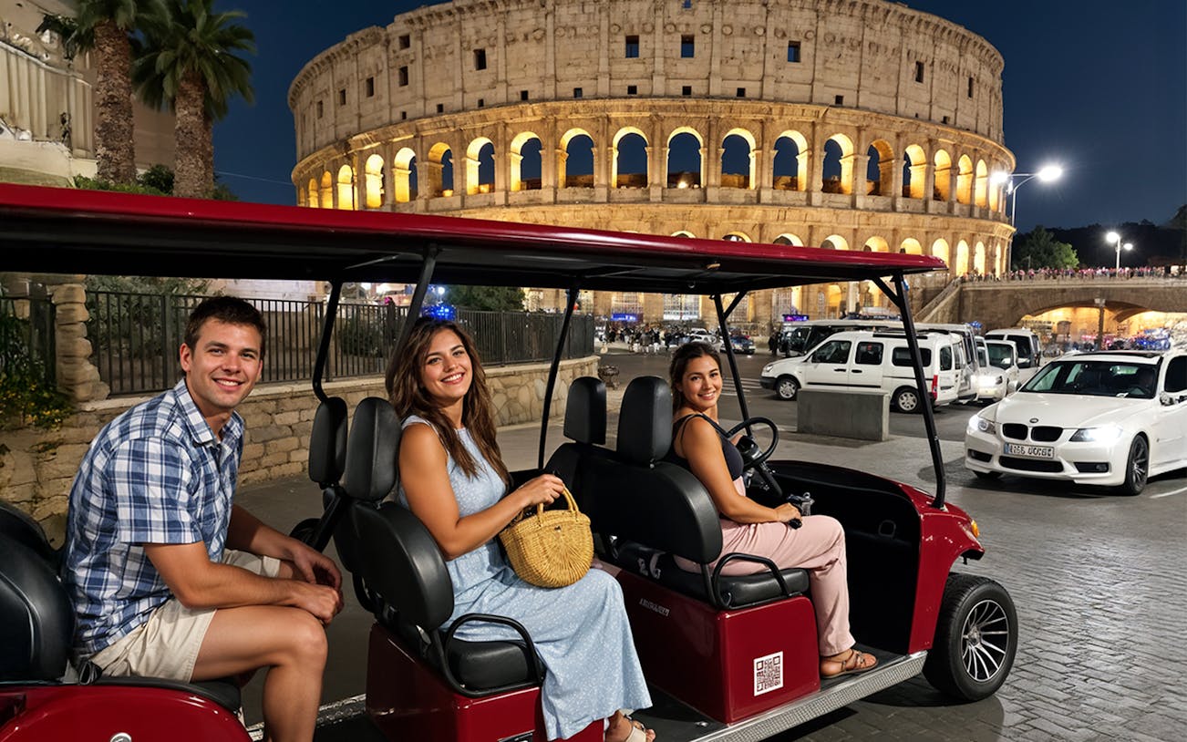 Tourists on a golf cart tour in front of the Colosseum at night, Rome.