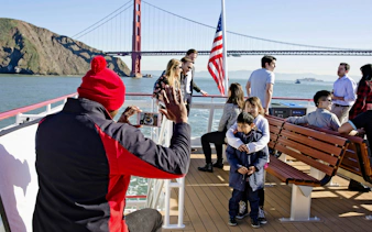 Cruise passengers enjoying views of the Golden Gate Bridge in San Francisco Bay.