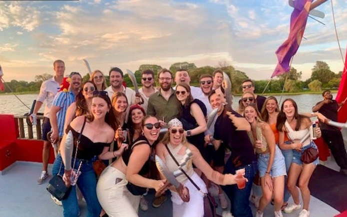 Group enjoying Boomerang Pirate Ship 21+ Party Cruise with drinks and views of DC monuments.