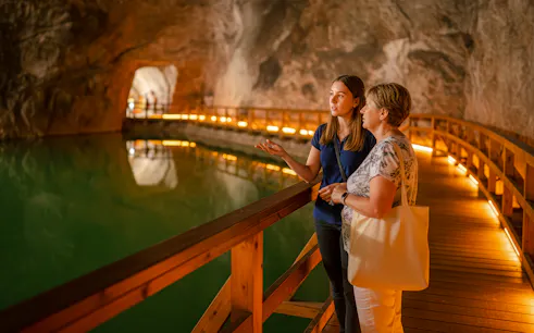 Guided tour of saltwater lake inside Wieliczka salt mine.