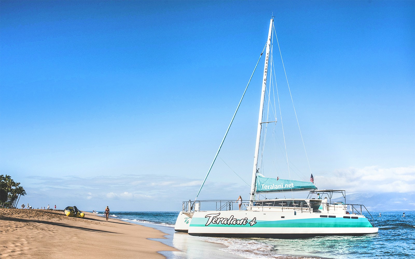 Catamaran on sandy beach for Luxury West Snorkel Sail and whale watching Tour in Maui, Hawaii.