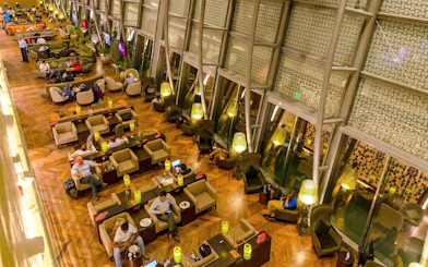 Primeclass Lounge seating area at Muscat International Airport's International Departures.