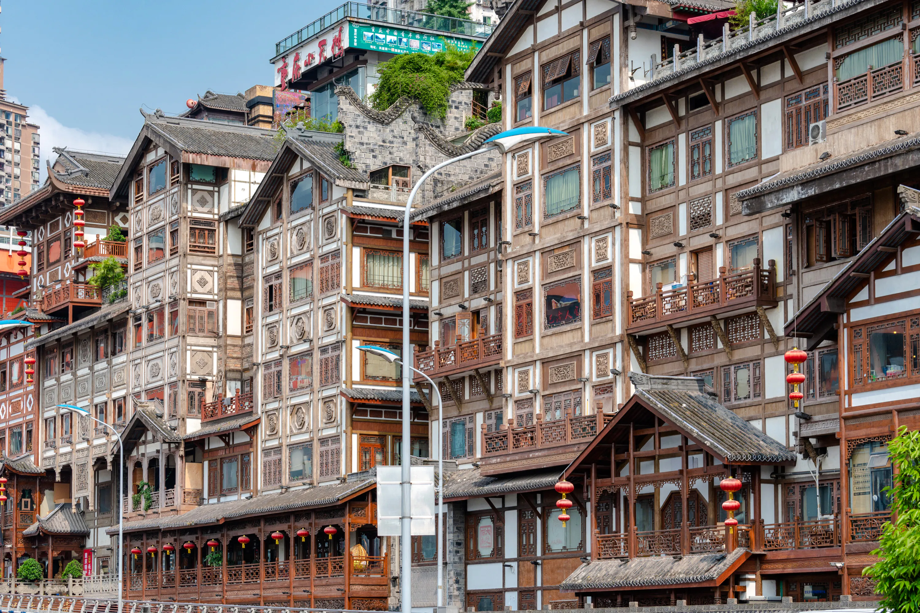 Traditional wooden buildings with intricate designs in Chongqing, part of the 8D Private Car Tour.