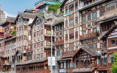 Traditional wooden buildings with intricate designs in Chongqing, part of the 8D Private Car Tour.