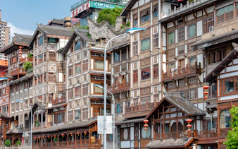 Traditional wooden buildings with intricate designs in Chongqing, part of the 8D Private Car Tour.