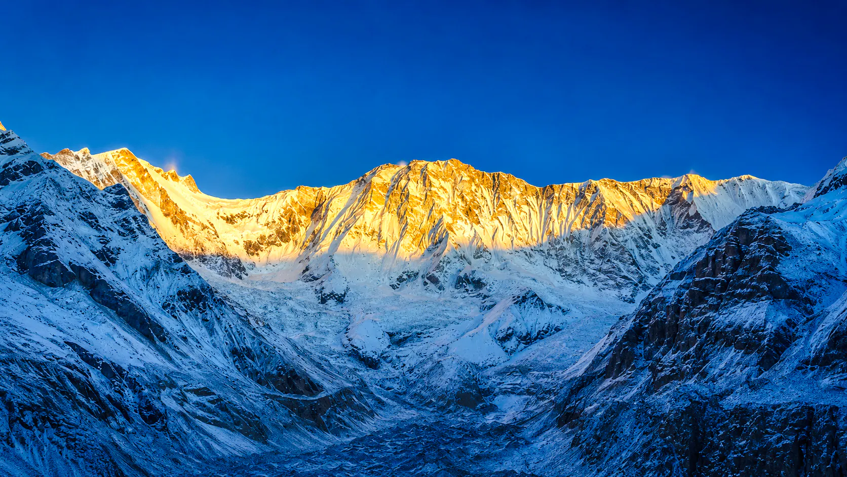 Annapurna Base Camp at sunrise with snow-covered peaks, Annapurna Region.