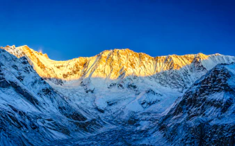 Annapurna Base Camp at sunrise with snow-covered peaks, Annapurna Region.