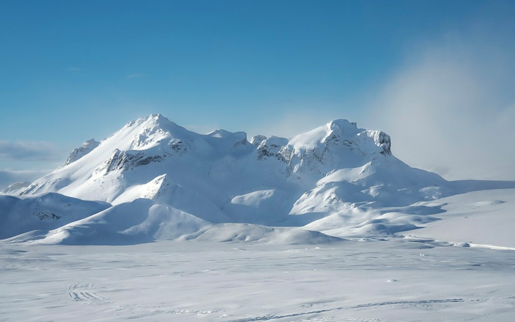 Langjökull Glacier's snow-covered peaks under a clear blue sky in Iceland.