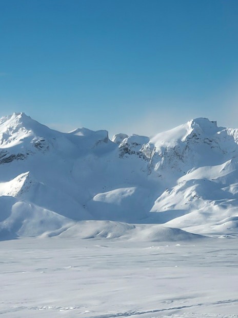 Langjökull Glacier's snow-covered peaks under a clear blue sky in Iceland.