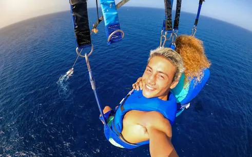 Parasailing over the Red Sea during a 1-hour glass boat ride in Sharm El Sheikh.