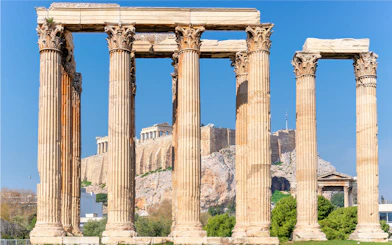 Temple of Olympian Zeus columns with Acropolis in background, Athens, Greece.