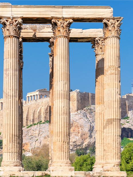 Temple of Olympian Zeus columns with Acropolis in background, Athens, Greece.