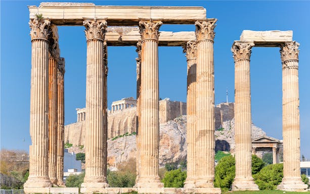 Temple of Olympian Zeus columns with Acropolis in background, Athens, Greece.