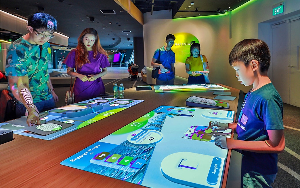 People interacting with digital exhibits at Petrosains, The Discovery Centre.