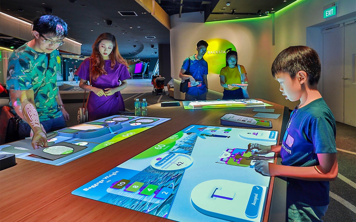 People interacting with digital exhibits at Petrosains, The Discovery Centre.