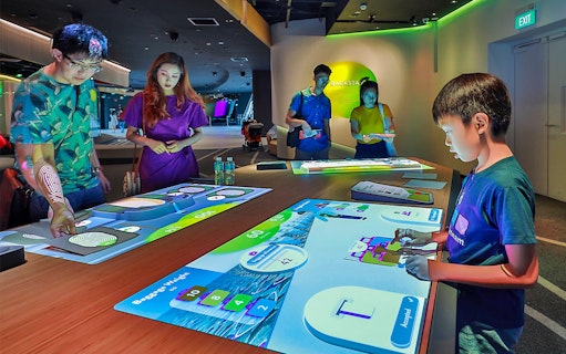 People interacting with digital exhibits at Petrosains, The Discovery Centre.