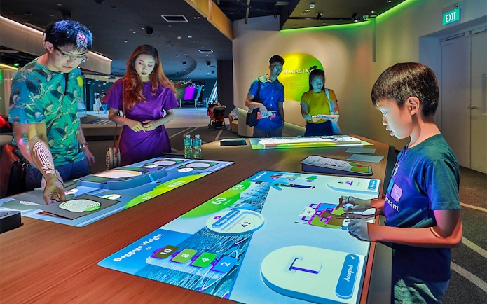 People interacting with digital exhibits at Petrosains, The Discovery Centre.