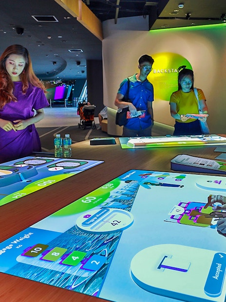 People interacting with digital exhibits at Petrosains, The Discovery Centre.