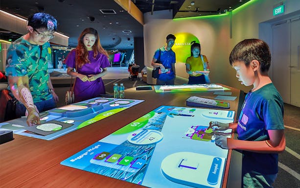 People interacting with digital exhibits at Petrosains, The Discovery Centre.