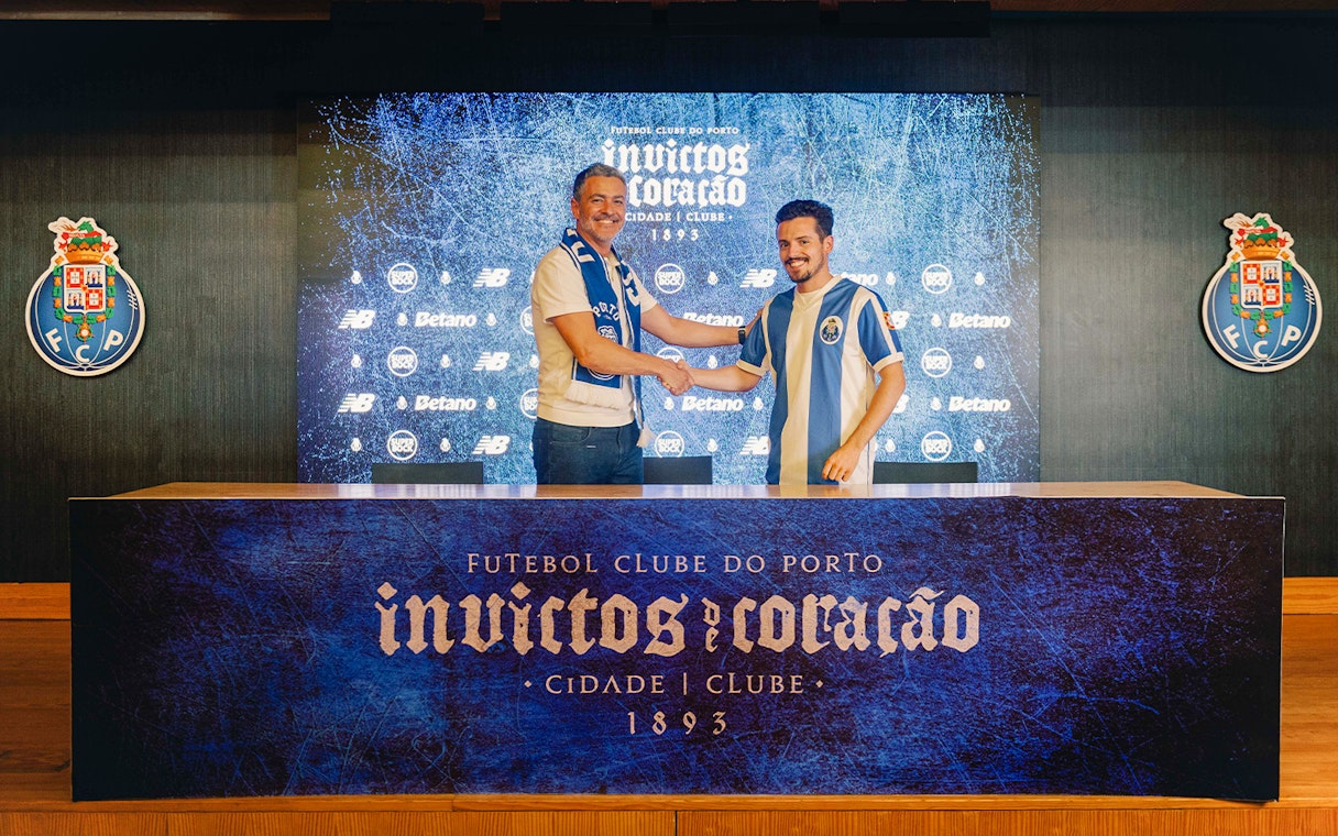 Visitors shaking hands in FC Porto stadium museum conference room.