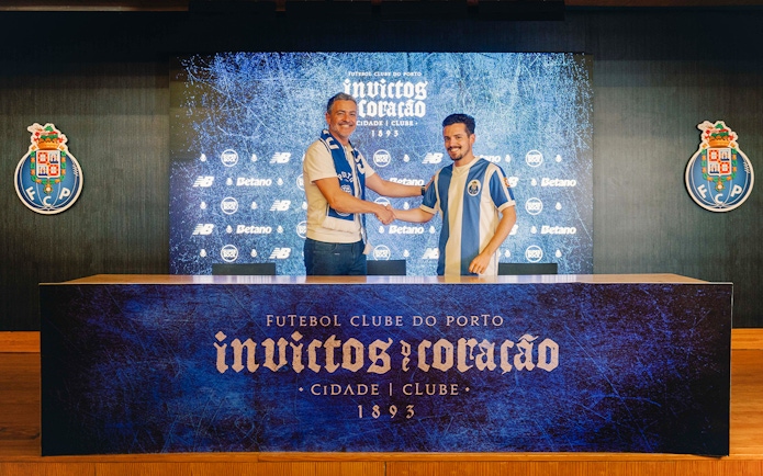 Visitors shaking hands in FC Porto stadium museum conference room.