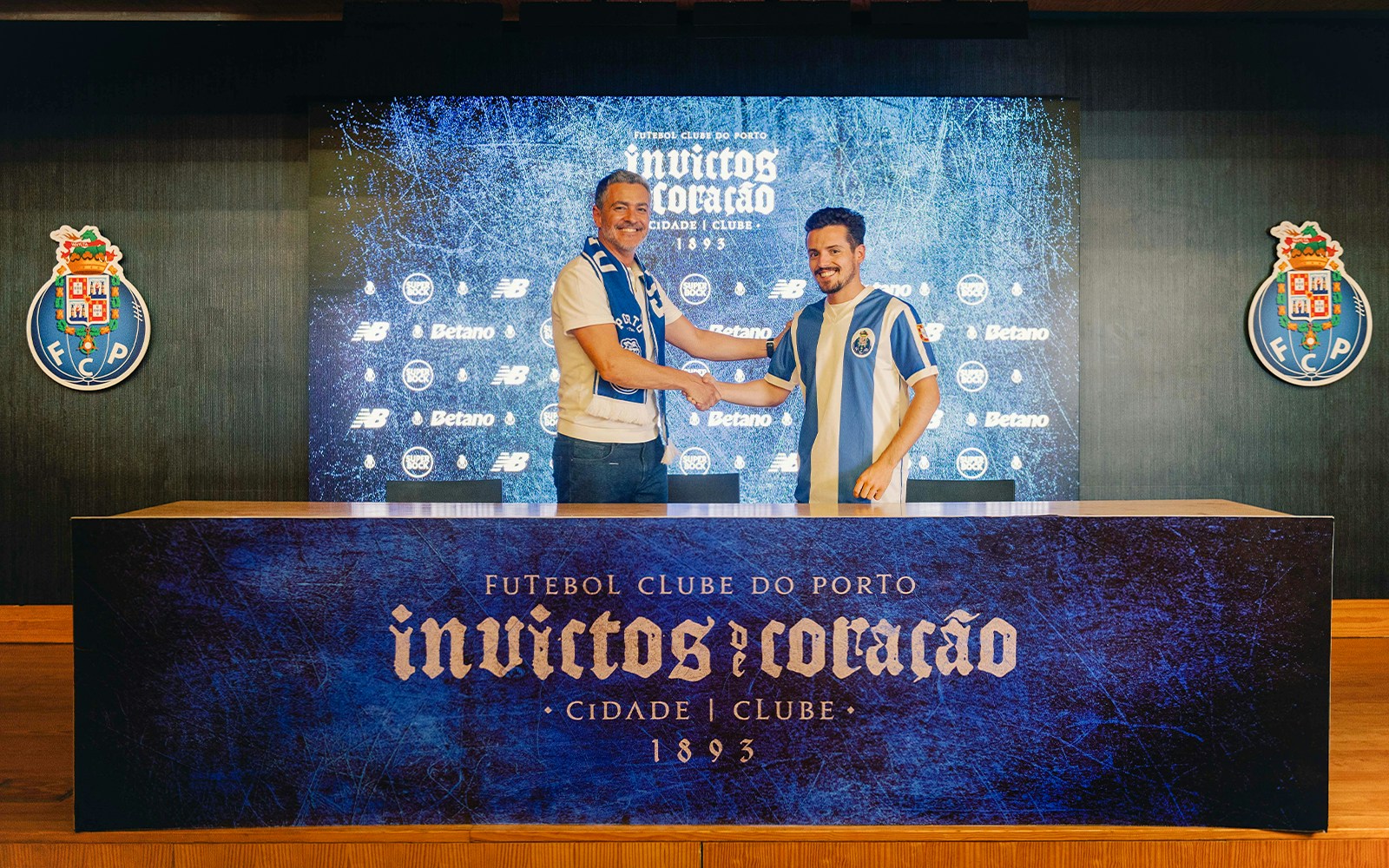 Visitors in FC Porto stadium museum conference room viewing historical exhibits.