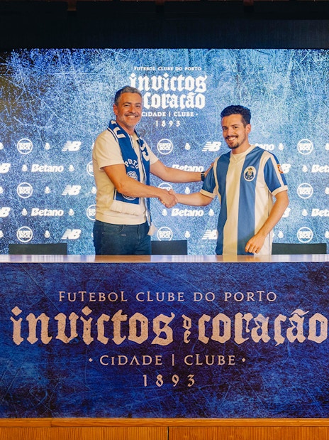 Visitors shaking hands in FC Porto stadium museum conference room.