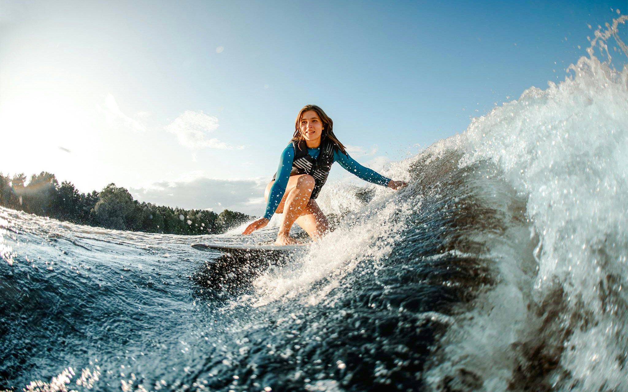 Woman wakeboarding on a wave in Dubai.