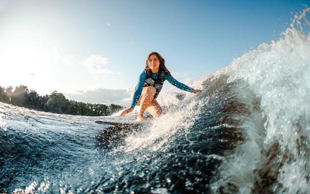Woman wakeboarding on a wave in Dubai.