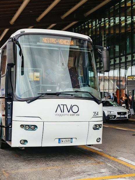 Bus at Venice airport terminal for passenger transfer.