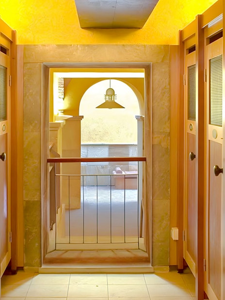 Lockers inside Rudas Thermal Spa with wooden doors and a view of the spa area.
