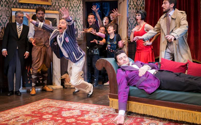 Actors in a comedic scene from "La Función Que Sale Mal" on stage.