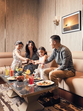 Family enjoying a meal at Plaza Premium Lounge Dubai.