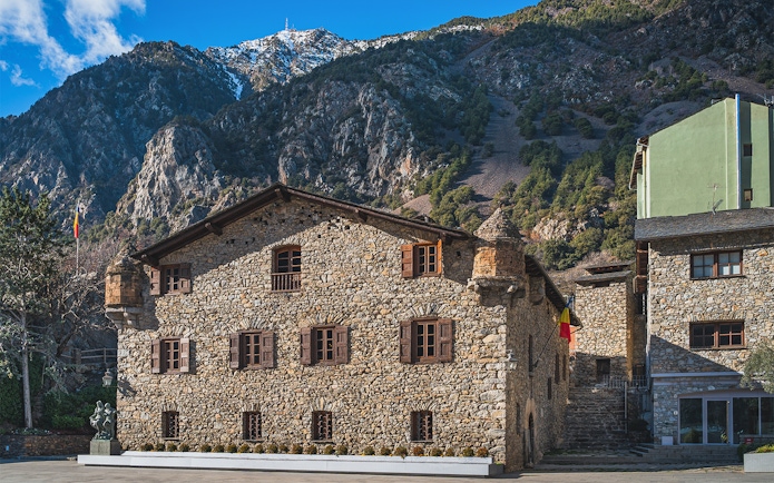 Stone building in Andorra with mountain backdrop on a full-day tour from Barcelona.