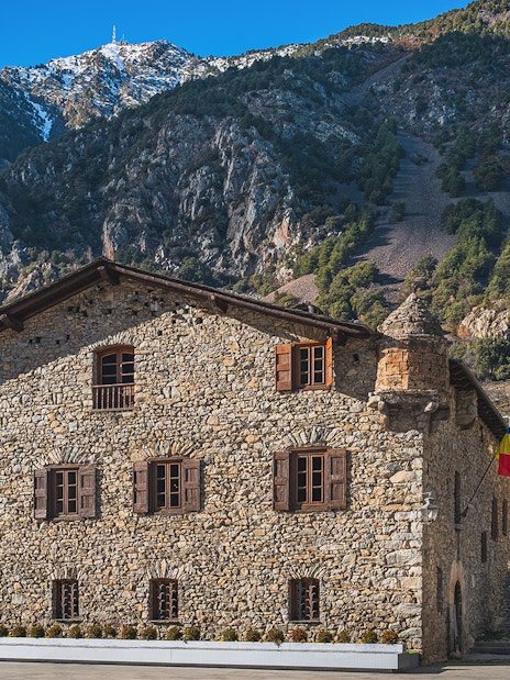 Stone building in Andorra with mountain backdrop on a full-day tour from Barcelona.