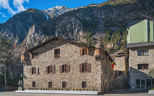 Stone building in Andorra with mountain backdrop on a full-day tour from Barcelona.