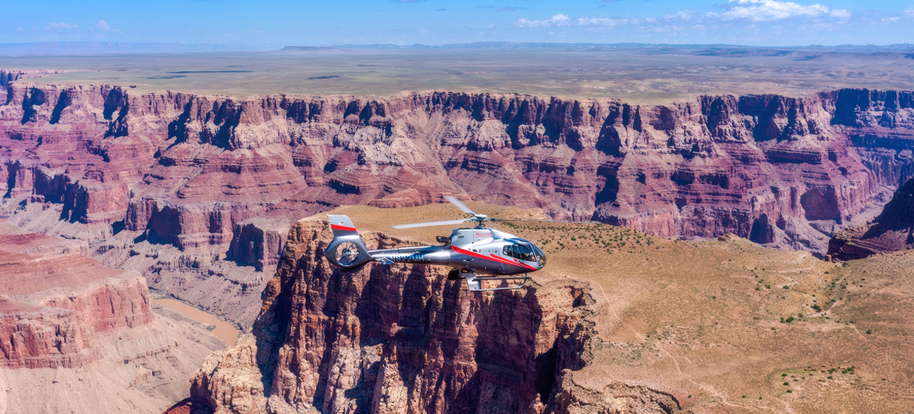 Maverick helicopter flying over the Grand Canyon.