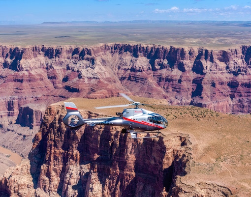 Maverick helicopter flying over the Grand Canyon.